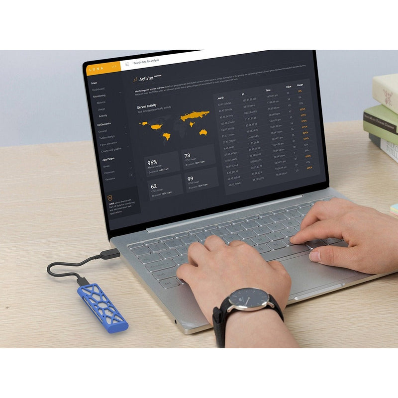 Load image into Gallery viewer, Image of the SSD enclosure plugged into a laptop that is in use to hold more information